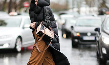 A woman wears a waterproof coat in the rain. PFAS are commonly used as waterproofing agents in clothing and textiles.