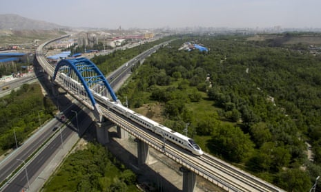 A high-speed train runs through the city of Urumqi, China.