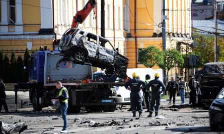 A crane removes a car destroyed by missile strikes on Kyiv