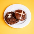 A Tesco Finest triple chocolate hot cross bun, sliced, toasted and buttered, on a white plate