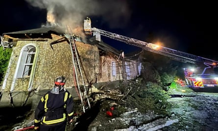Ukrainian rescuers try to put out a fire after a Russian drone hit a private building in a village of Kyiv region.