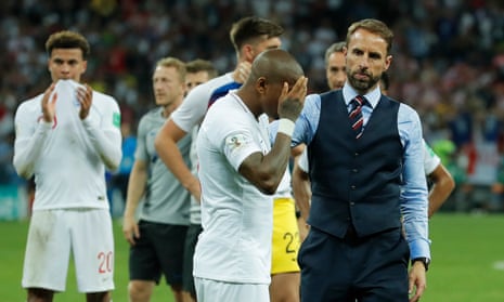 Gareth Southgate consoles Ashley Young on the pitch after England’s exit from the World Cup