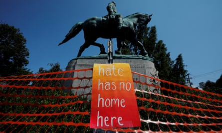 A monument to Confederate general Robert E Lee is adorned with an anti-hate sign.