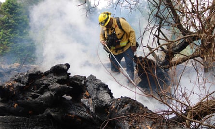 Firefighters put out spot fires on Pie Ranch in California on 24 August.