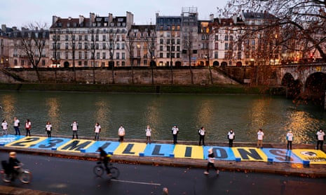 Activists lay out a banner in Paris highlighting the 2.3 million people who signed a petition