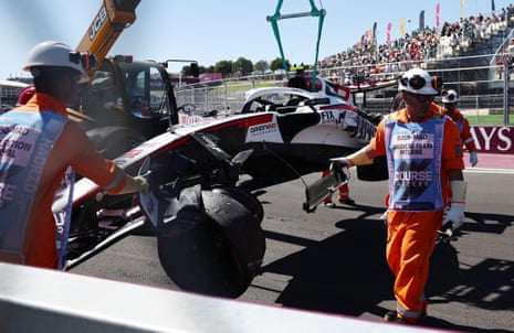 Oliver Bearman’s car is lifted up by a crane after crashing during practice
