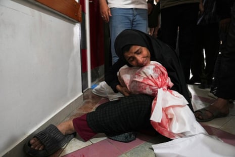 A Palestinian woman mourns her son, killed in Israeli airstrikes.