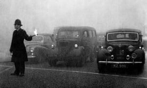 A policeman controlling traffic during the great smog in London in 1952.