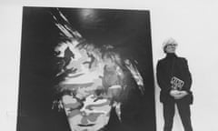 Andy Warhol pictured in 1986 with a self portrait