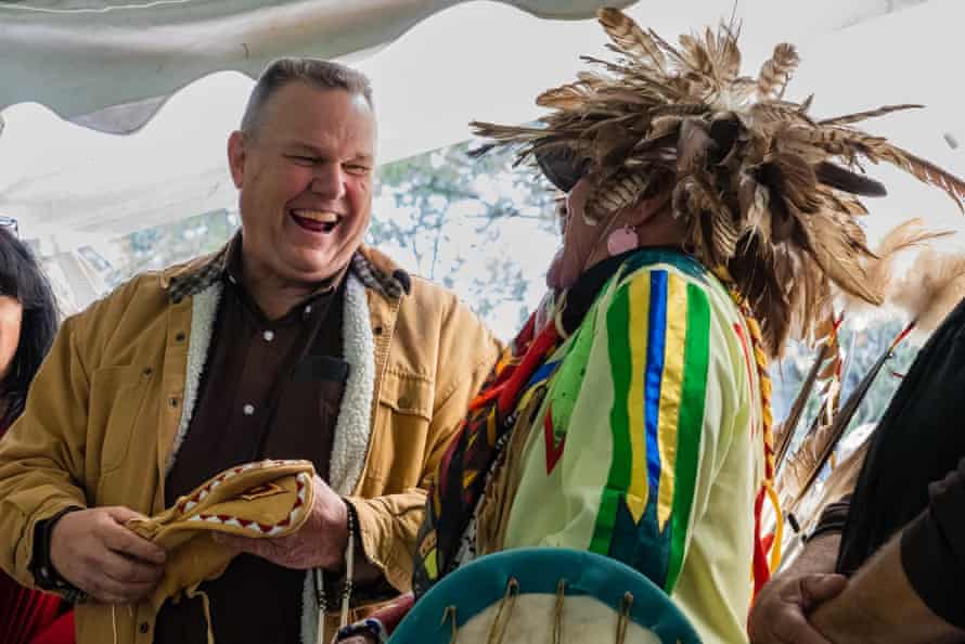 Democrat senator Jon Tester accepts a gift from CSKT tribal member Jim Malatare. ‘Righting a historical wrong is an important reason to celebrate,’ Tester said.