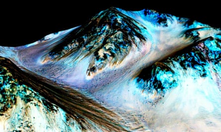 Dark, narrow, 100 meter-long streaks on Mars inferred to have been formed by contemporary flowing water are seen in a Nasa image.
