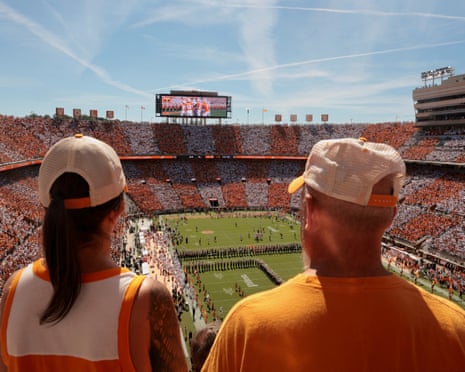 Tennessee fans watch a marching band perform below packed stands at Neyland Stadium