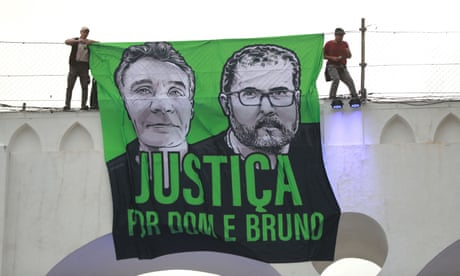 Protesters in Rio de Janeiro with a banner calling for justice for the murders of Bruno Pereira and Dom Phillips