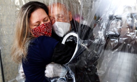 Maria Paula Moraes hugs her father through a ‘hug curtain’ in São Paulo, Brazil, in July.