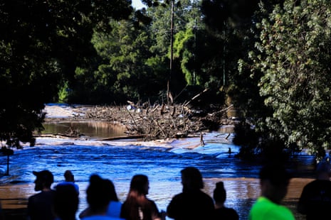 People look on at the submerged Richmond Bridge at North Richmond in Sydney on Saturday.