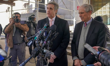 Michael Cohen, center, is joined by his attorney Lanny Davis as he speaks to reporters after a second day of testimony in New York on 15 March.