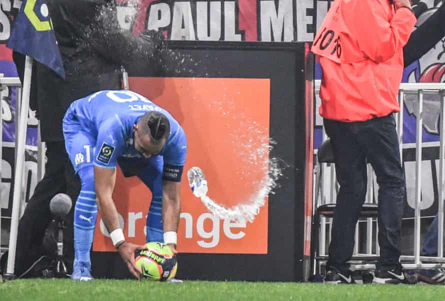 Dimitri Payet is struck in the head with a water bottle thrown by a Lyon fan.