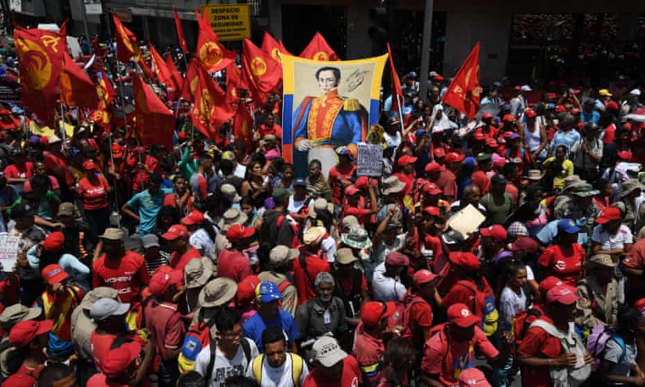 Supporters of Maduro display an image of the South American liberator Simon Bolivar during a May Day rally in Caracas on 1 May 2019.