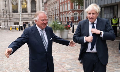 Prime Minister Boris Johnson and JCB chairman Lord Bamford at the unveiling of JCB product in central London in 2021.