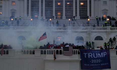 Supporters of Donald Trump wreathed in tear gas as they attack the US Capitol in Washington, DC, during a clash with police officers defending the US Congress as it sought to certify Joe Biden’s presidential victory on January 6, 2021.