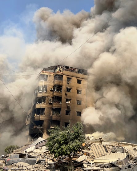 Smoke engulfs a collapsing building in Beirut’s southern suburbs.