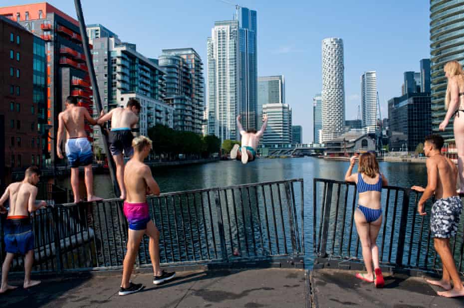 People in swimwear on bridge