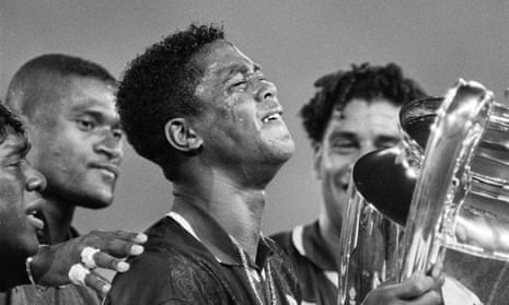 Ajax’s Patrick Kluivert holds the Champions League trophy after scoring the only goal of the final against Milan.