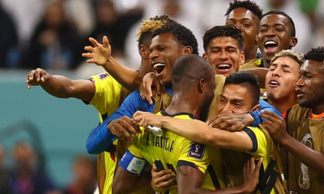 The Ecuador players celebrate in a huddle.
