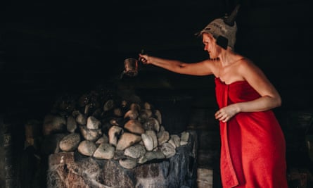 Pouring water on the hot stones inside the Mooska smoke sauna.