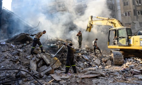 Lebanese firefighters, first responders and security forces at work after Israeli airstrikes in a crowded central district of Beirut on Friday.