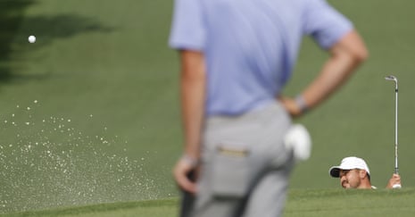 Jason Day hits out from the sand on the 7th.