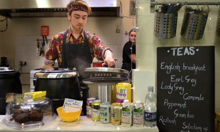 Member of staff serving behind the counter at the Sidney Street Cafe, Manchester