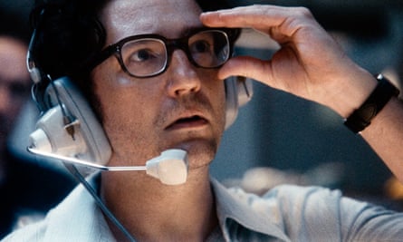 close-up of man wearing headset, adjusting his glasses