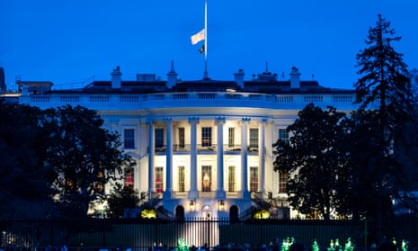 Biden calls Jimmy Carter ‘a statesman and a humanitarian’ as funeral details announced – latest updates A blue-toned night sky above the White House, where an American flag flies at half mast