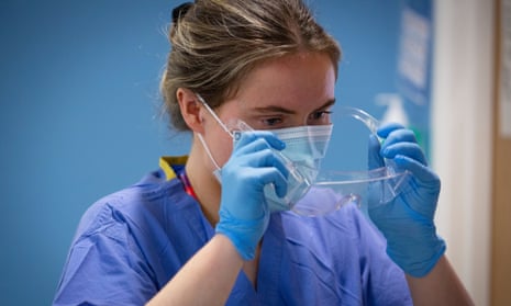 Student nurse applying PPE, goggles, face masks, aprons and gloves.