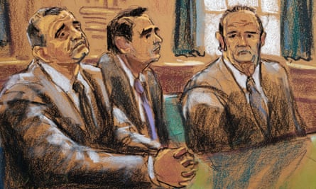 Lev Parnas, left, and Igor Fruman sit either side of lawyer Todd Blanche during their arraignment in New York City on 23 October 23.