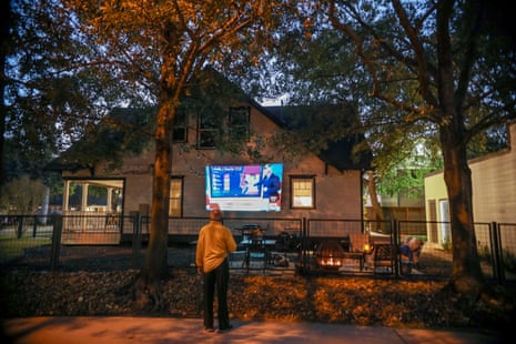 A house projects a television monitor showing election results in Houston, United States.