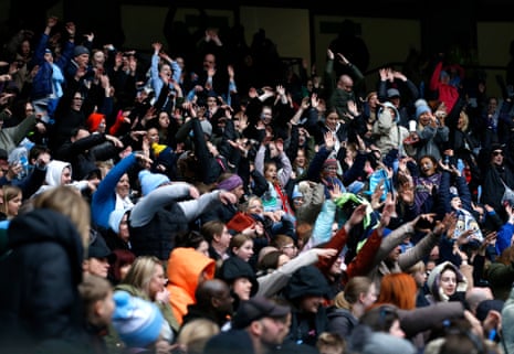 Manchester City fans do a Mexican wave during the Women’s Super League game against Manchester United.
