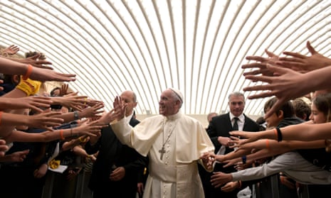Pope Francis is greeted by schoolchildren during an audience at the Vatican