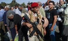 Russian military policeman guards the passage at the check-point of the de-escalation zone near Homs, Syria.