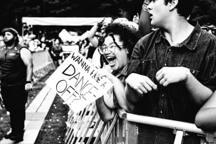 cheering fan holds sign that says ‘wanna have a dance-off?’