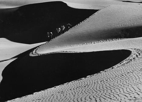Four figures cross sand dunes