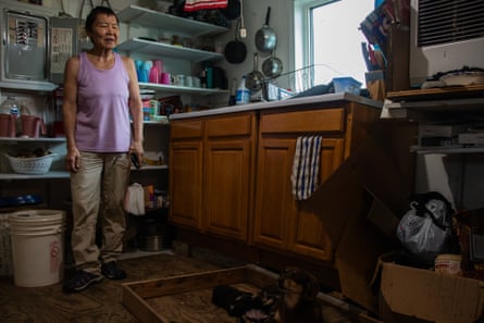 A woman stands in her kitchen
