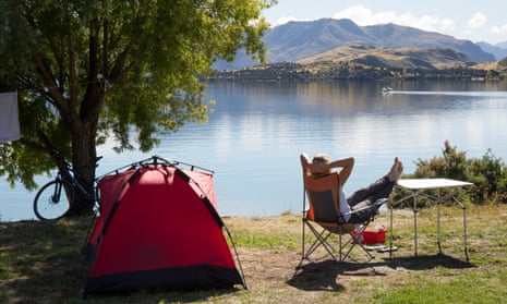 Woman camping by a lake