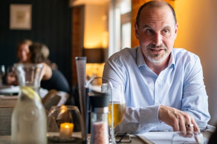 Julian sitting at a restaurant table