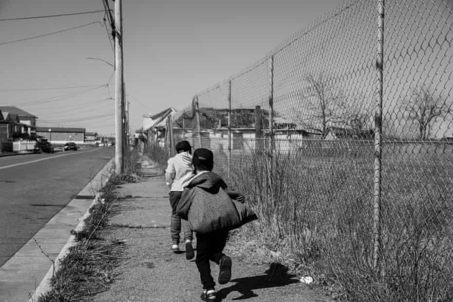 Kimberly White Smalls’ grandsons – Donovan E Smalls, 9, left, and Kelsey E Smalls Jr, 8 – running down the street in Far Rockaway, Queens.