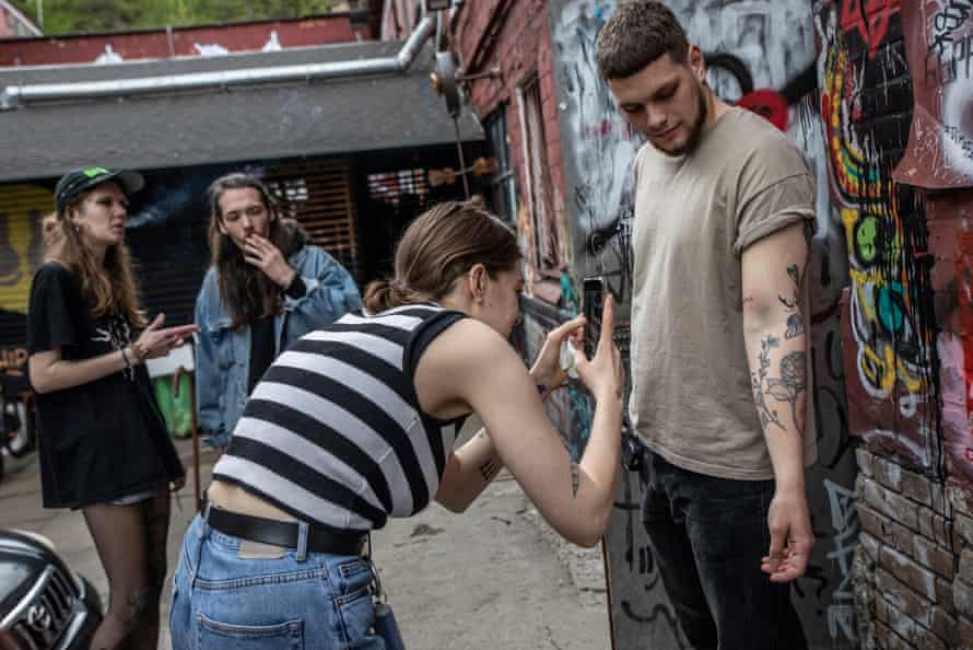 Tattoo artist Marika checks on a client's tattoo of the Ukrainian word Palyanytsia. Palyanytsia is a traditional Ukrainian flatbread that has become a very popular keyword for identifying a Russian occupier.