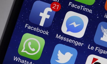 Mobile phone showing Facebook and Messenger icons