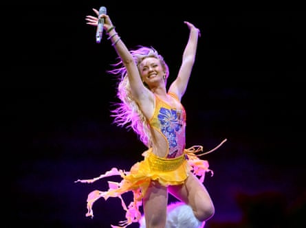 Zara Larsson on stage with her arms in the air