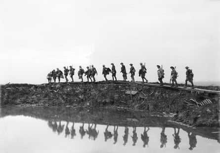 ‘Supporting troops of the 1st Australian Division walking on a duckboard track near Hooge, in the Ypres sector. They form a silhouette against the sky as they pass towards the front line to relieve their comrades, whose attack the day before won Broodseinde Ridge and deepened the Australian advance.’ 5 October 1917